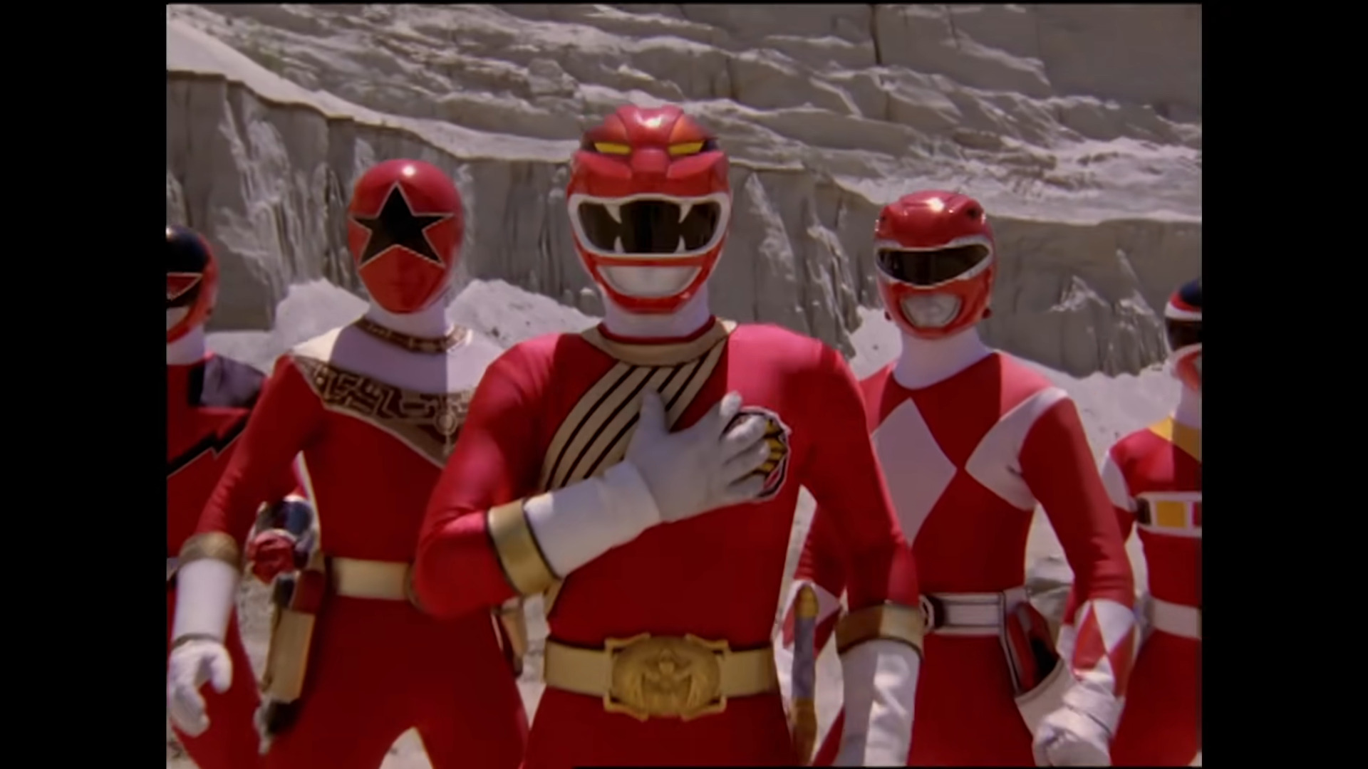 The Red Lion Wild Force (Ricardo Medina Jr.) stands with his allies in Power Rangers Wild Force Episode 34 "Forever Red" (2002), Hasbro (Footage originally from Gaoranger vs. Super Sentai, Forever Red (2001), Toei Co. Ltd.)