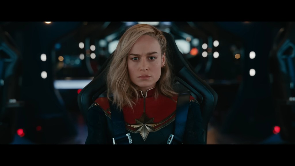 Carol Danvers (Brie Larson) receives a transmission from Nick Fury (Samuel L. Jackson) in The Marvels (2023), Marvel Entertainment