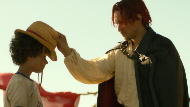 One Piece. (L to R) Colton Osorio as Young Luffy, Peter Gadiot as Shanks in season 1 of One Piece. Cr. Courtesy of Netflix © 2023