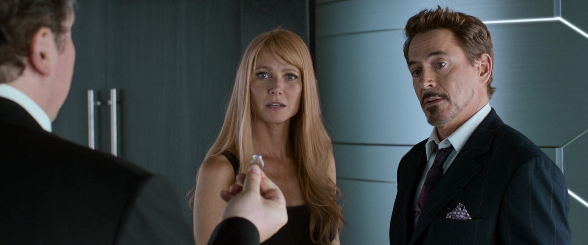 Tony Stark (Robert Downey Jr.) and Pepper Potts (Gwenyth Paltrow) take Happy's (Jon Favreau) suggestion to announce their engagement in place of Spider-Man's (Tom Holland) Avengers membership in Spider-Man: Homecoming (2017), Marvel Entertainment