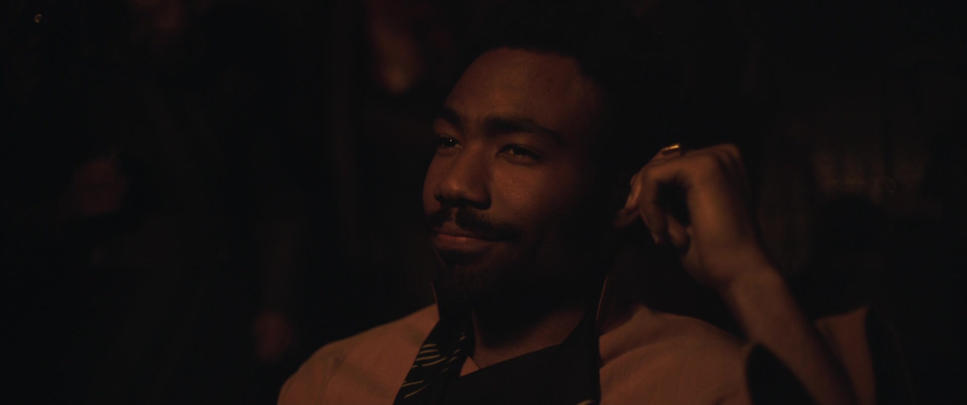 Lando Calrissian (Donald Glover) attempts to smooth talk his way out of a bad bet in Solo: A Star Wars Story (2018), Lucasfilm