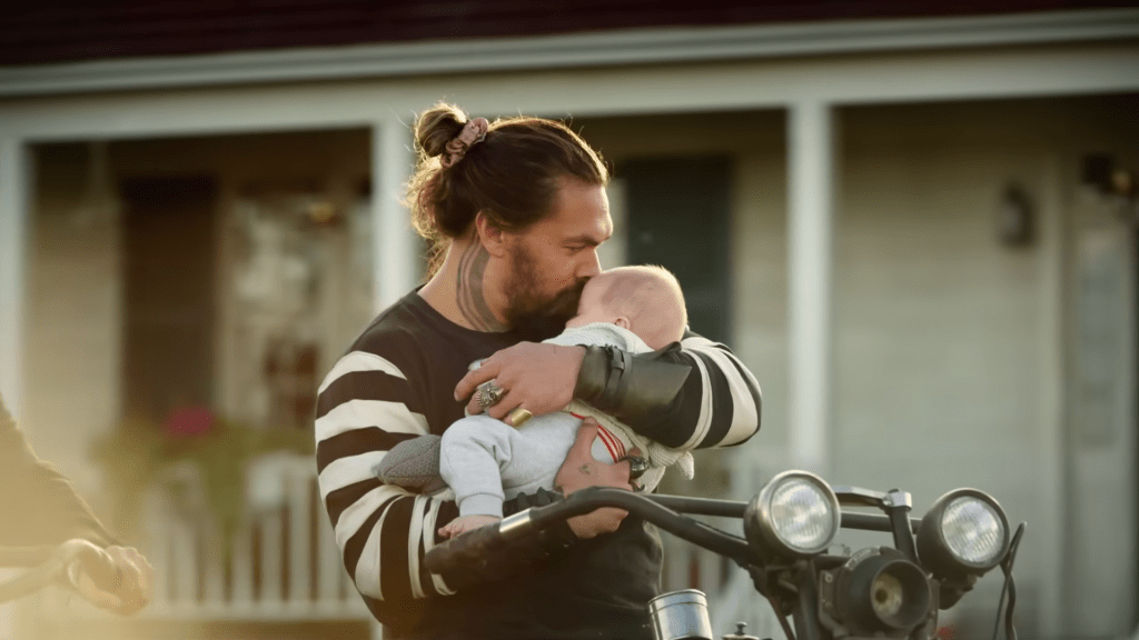 Arthur Curry (Jason Momoa) holds his newborn son in Aquaman and the Lost Kingdom (2023), Warner Bros. Pictures