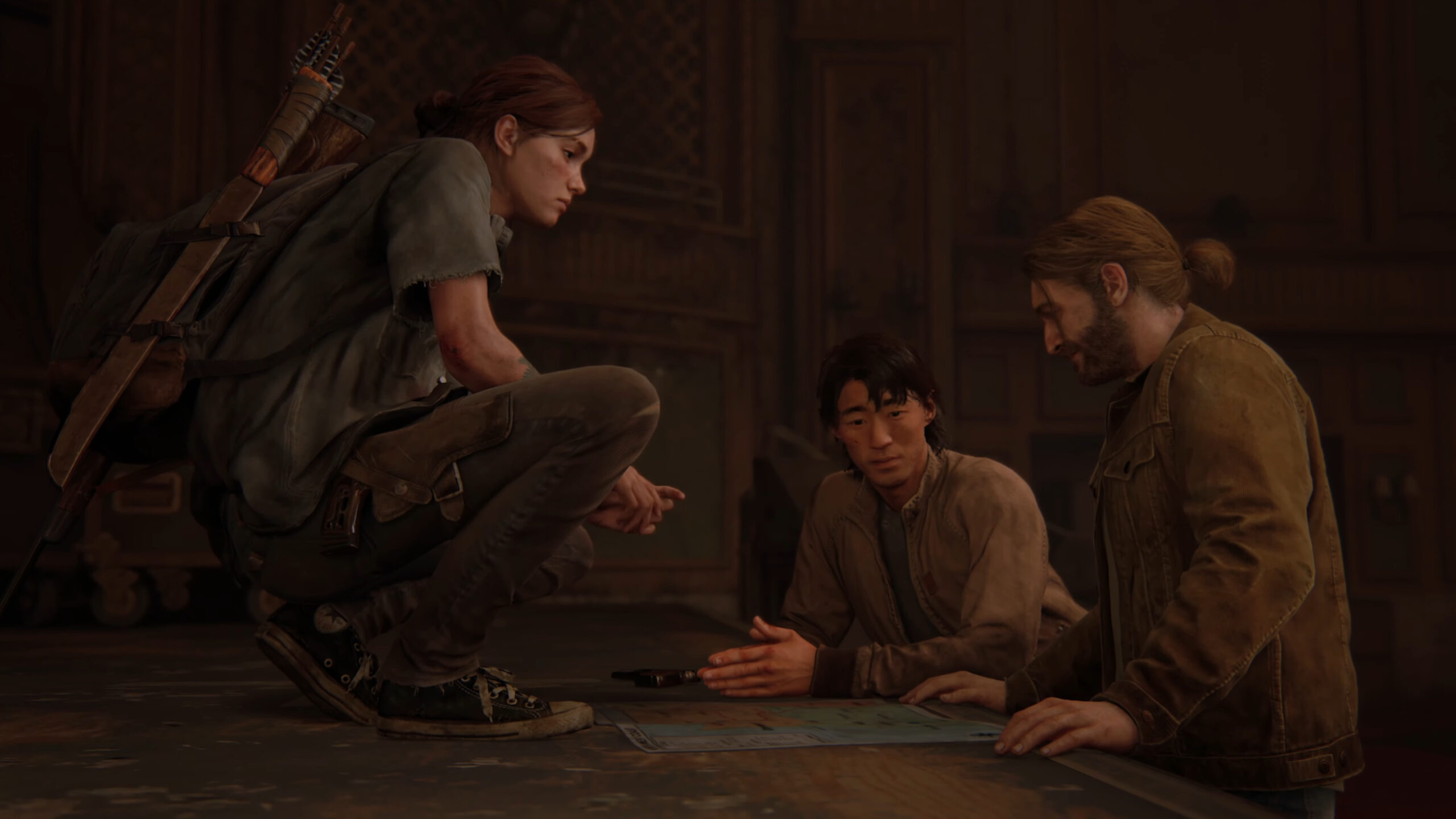 Ellie (Ashley Johnson), Jesse (Stephen Chang) and Tommy (Jeffrey Pierce) map out their next move in The Last of Us Part II (2020), Naughty Dog