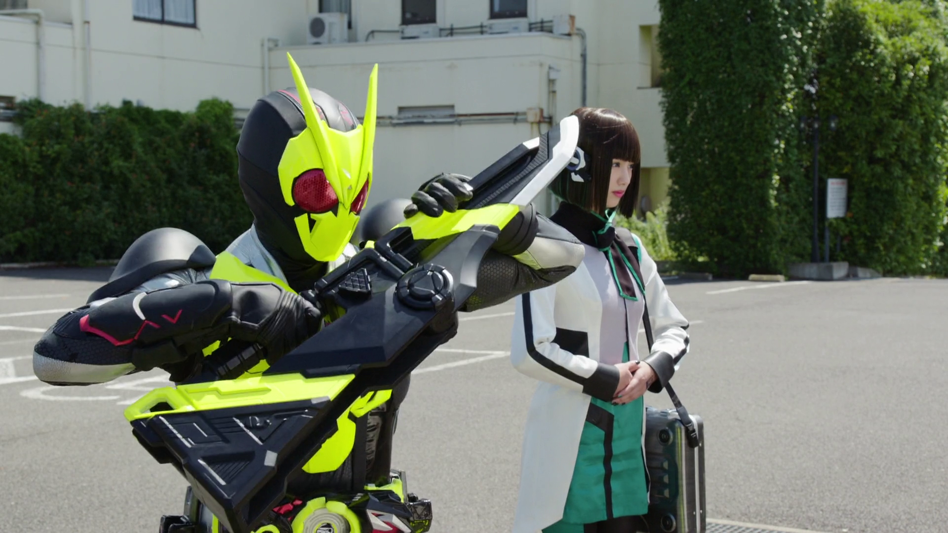 Aruto (Fumiya Takahashi) suits up as Izu (Noa Tsurushima) looks on in Kamen Rider Zero-One Episode 5 "His Passionate Manga Path" (2019), Toei Co. Ltd.