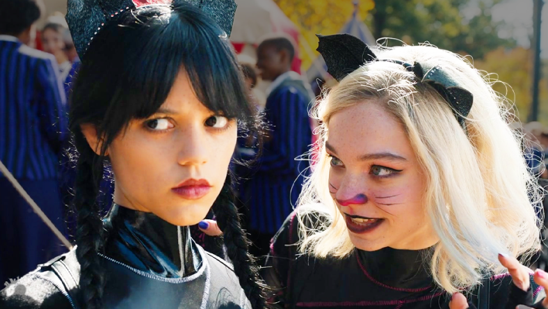 Wednesday (Jenna Ortega) and Enid (Emma Myers) emerge from the canoe race victorious in Wednesday Season 1 Episode 2 "Woe Is The Loneliest Number" (2022), Netflix