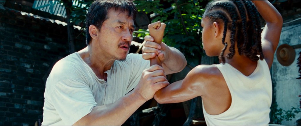 Mr. Han (Jackie Chan) prepares to give Dre (Jaden Smith) his first martial arts lesson in The Karate Kid (2010), Sony Pictures