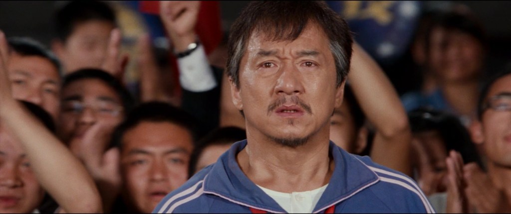 Mr. Han (Jackie Chan) looks on as his pupil Dre (Jaden Smith) faces his toughest battle yet in The Karate Kid (2010), Sony Pictures