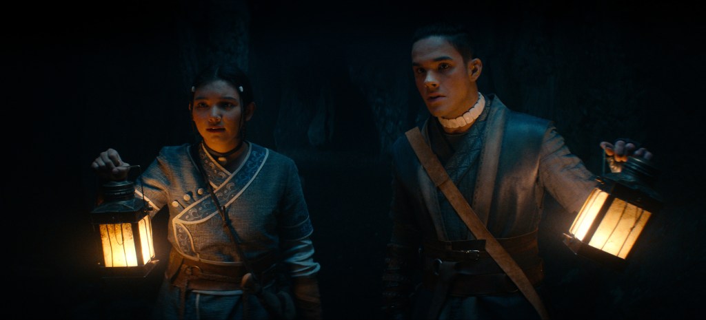 (Katara) Kiawentiio and Sokka (Ian Ousley) light the way in Avatar: The Last Airbender (2024), Netflix