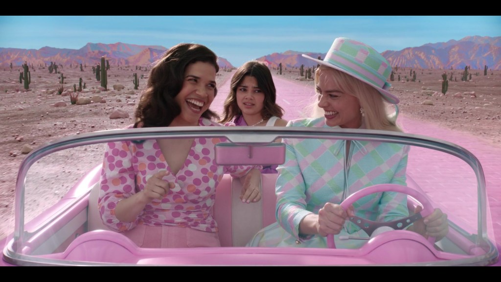 Gloria (America Ferrera), Sasha (Ariana Greenblatt), and Barbie (Margot Robbie) leave the Real World for Barbieland in Barbie (2023), Warner Bros. Pictures