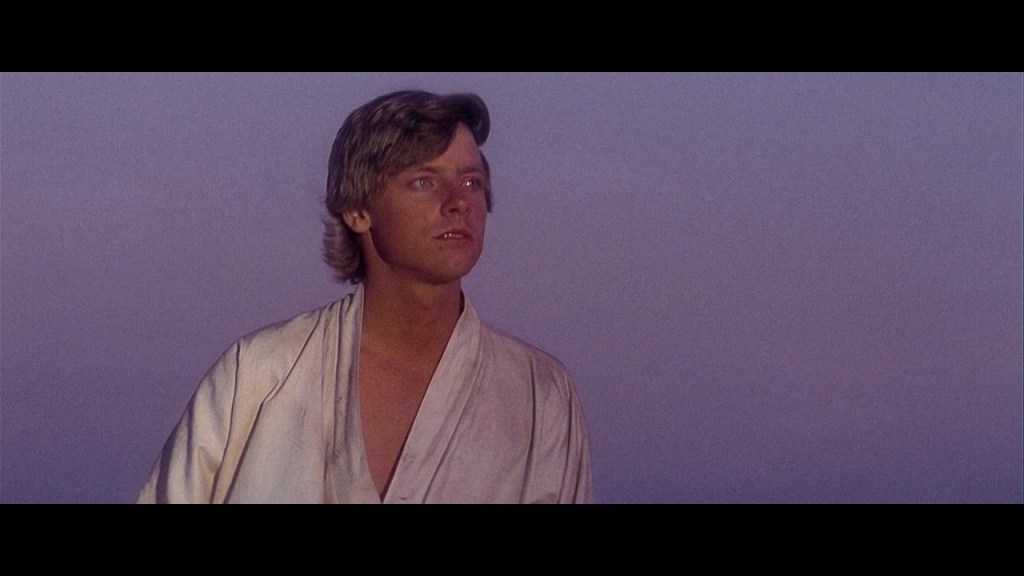 Luke Skywalker (Mark Hamill) gazes off at Tattooine's setting twin suns in Star Wars - Episode IV: A New Hope (1977), Lucasfilm