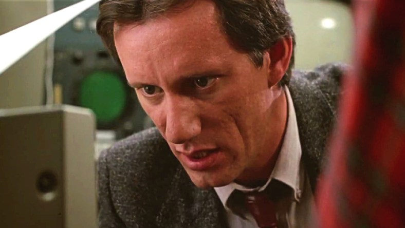 Max Renn (James Woods) has his head buried in media in Videodrome (1983), Universal Pictures