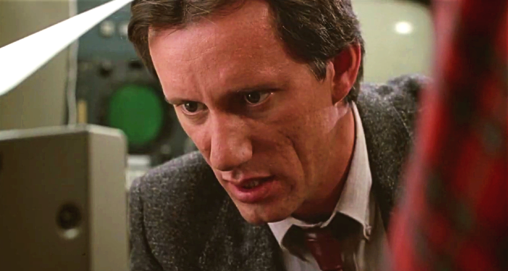 Max Renn (James Woods) has his head buried in media in Videodrome (1983), Universal Pictures
