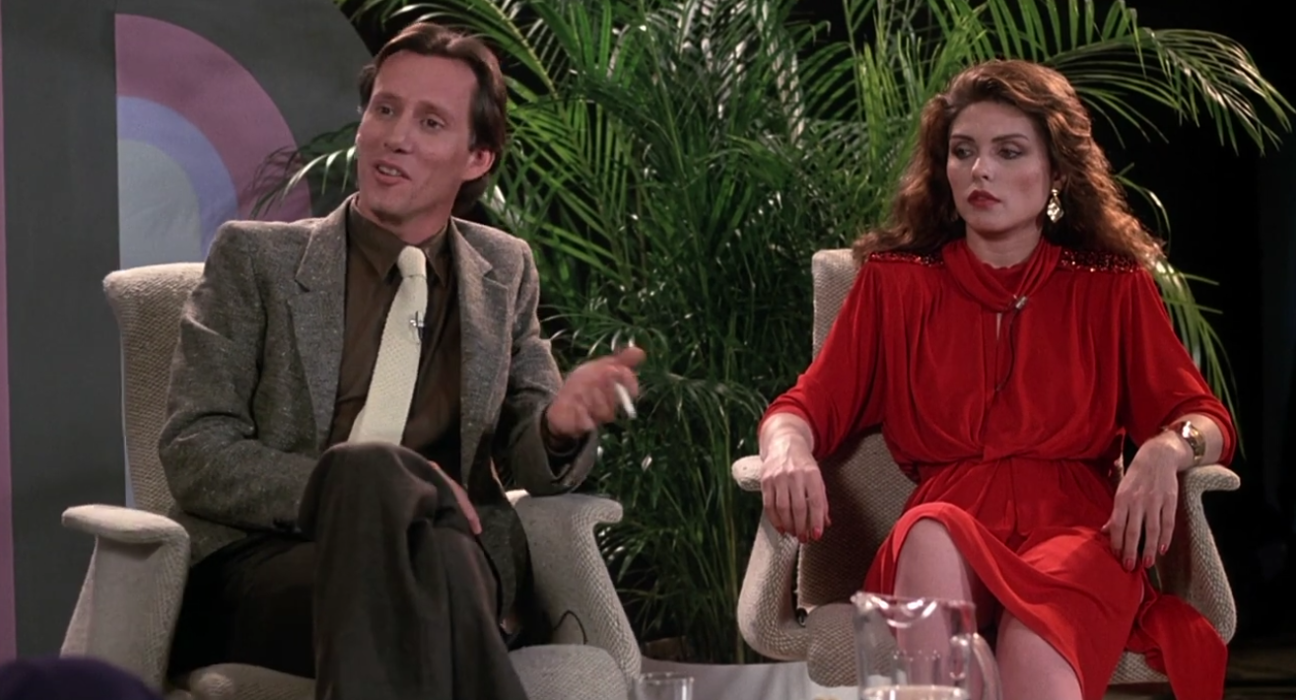 Max Renn (James Woods) and Nicki Brand (Debbie Harry) debate degeneracy on a talk show in Videodrome (1983), Universal Pictures