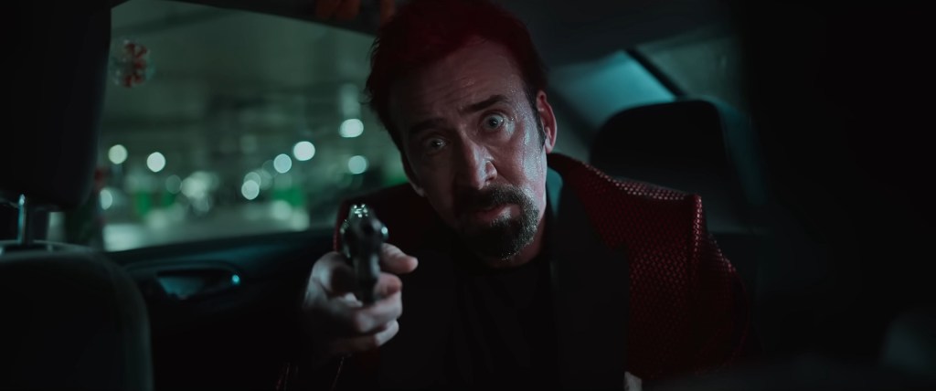 The Passenger (Nicolas Cage) threatens expecting father David Chamberlain (Joel Kinnaman) in Sympathy for the Devil (2023), RLJE Films