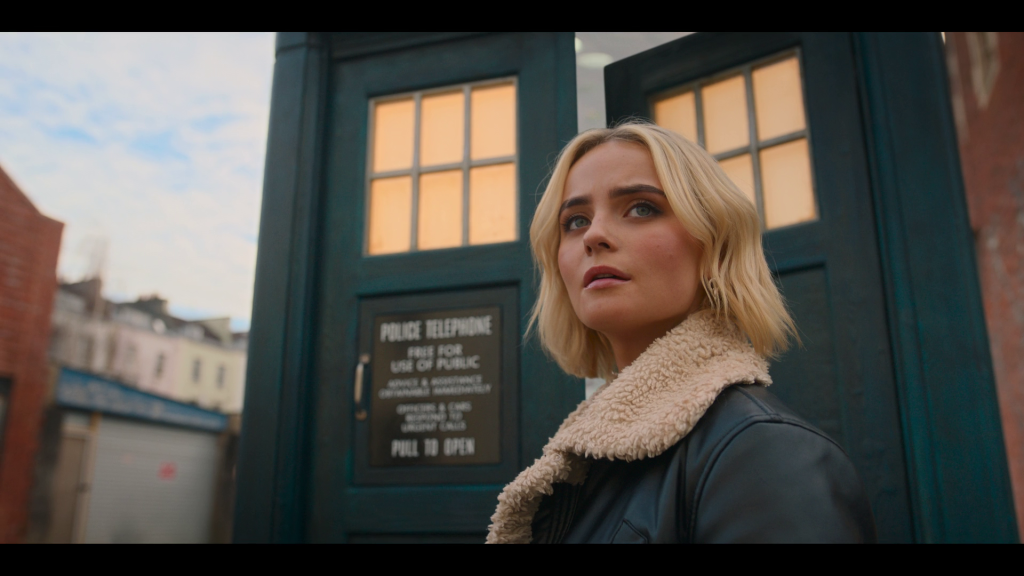 Ruby (Millie Gibson) prepares to take her first step inside the TARDIS in Doctor Who Series 14 Episode 0 "The Church On Ruby Road" (2023), BBC