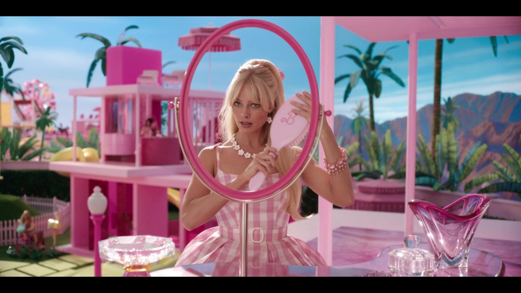 Barbie (Margot Robbie) gets ready for her day in Barbie (2023), Warner Bros. Pictures