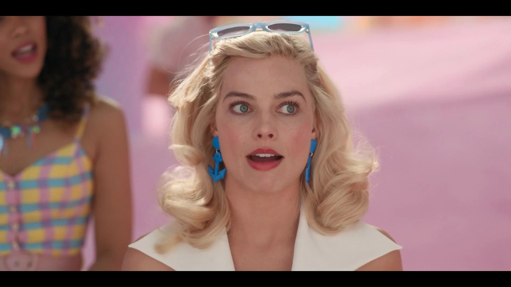 Barbie (Margot Robbie) recounts her recent weirdness in Barbie (2023), Warner Bros. Pictures