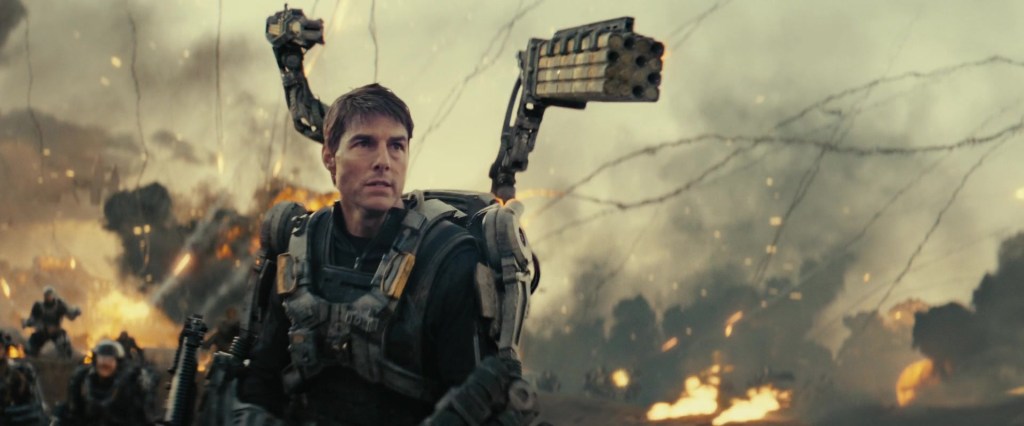 Major Cage (Tom Cruise) gets the hang of his combat jacket's weaponry in Edge of Tomorrow (2014), Warner Bros. Pictures