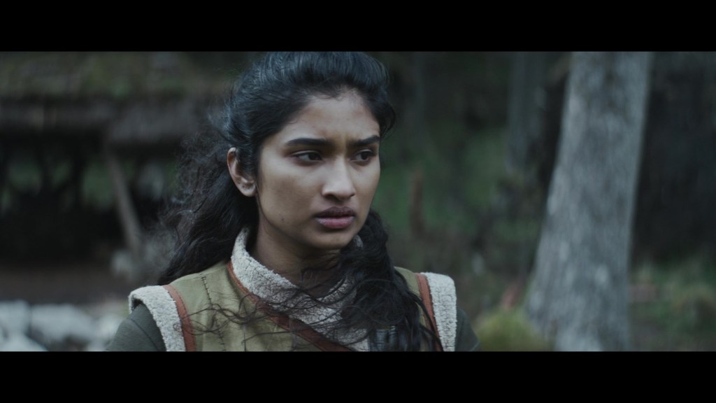 Cinta Kaz (Varada Seethu) senses trouble brewing amongst the camp on Aldhani in Andor Season 1 Episode 5 "The Axe Forgets" (2022), Disney