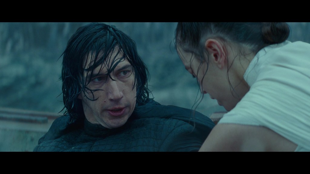 Kylo Ren (Adam Driver) is stunned at Rey's (Daisy Ridley) willingness to Force Heal him in Star Wars: Episode IX - The Rise of Skywalker (2019), Disney
