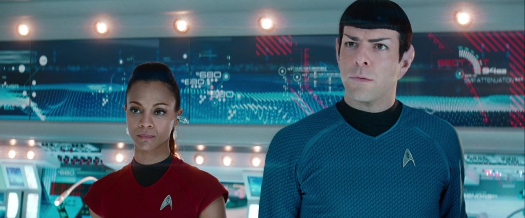Uhura (Zoe Saldaña) and Spock (Zachary Quinto) receive orders from Kirk (Chris Pine) in Star Trek Into Darkness (2013), Paramount Pictures