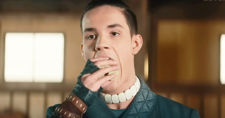 Sokka (Ian Ousley) grabs a bite to eat in Avatar: The Last Airbender (2024), Netflix