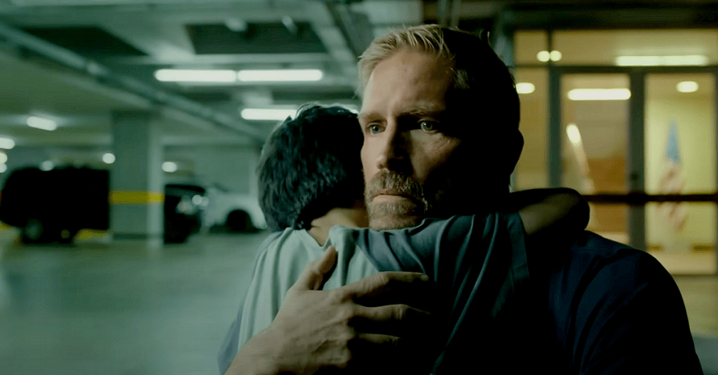 Tim Ballard (Jim Caviezel) is embraced by Miguel (Lucás Ávila) after rescuing him from sex traffickers in "Sound of Freedom" (2023), Angel Studios