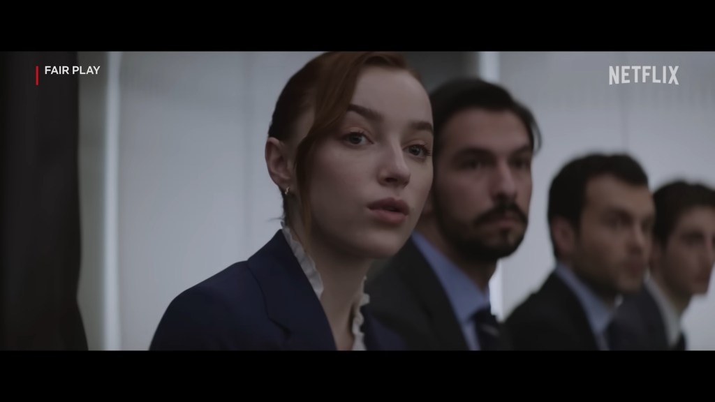 Emily (Phoebe Dynevor) watches on as her now-former co-worker smashes up his office in Fair Play (2023), Netflix