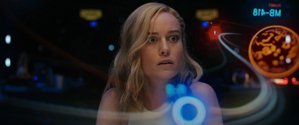 Captain Marvel (Brie Larson) receives an emergency transmission from Nick Fury (Samuel L. Jackson) in The Marvels (2023), Marvel Entertainment