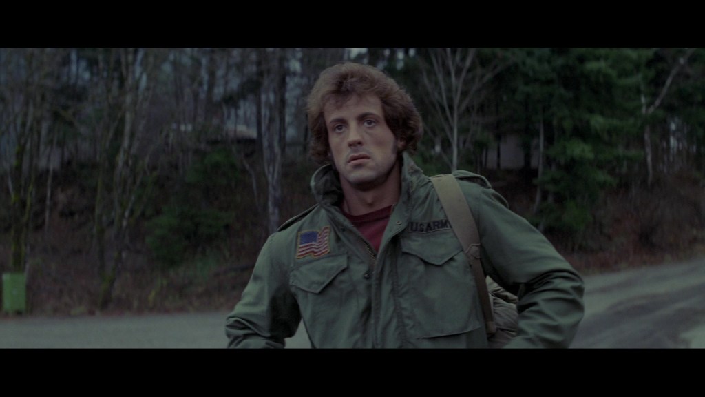 Rambo (Sylvester Stallone) arrives in Hope, Washington in First Blood (1982), Carolco Pictures