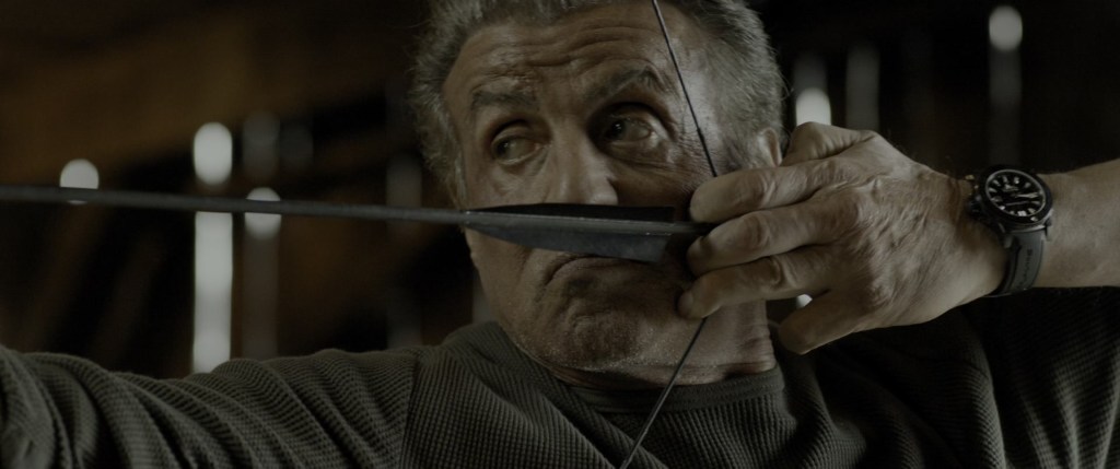 Rambo (Sylvester Stallone) tests the pull on his bow in Rambo: Last Blood (2019), Millenium Media