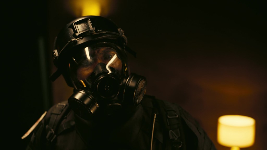 John David Washington under a gas mask in Tenet (2020), Warner Bros. Pictures