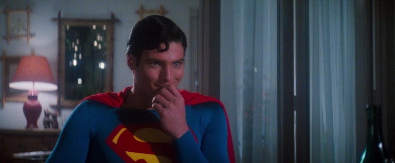 Superman (Christopher Reeve) is amused by something Lois (Margot Kidder) asks in Superman: The Movie (1978), Warner Bros. Pictures