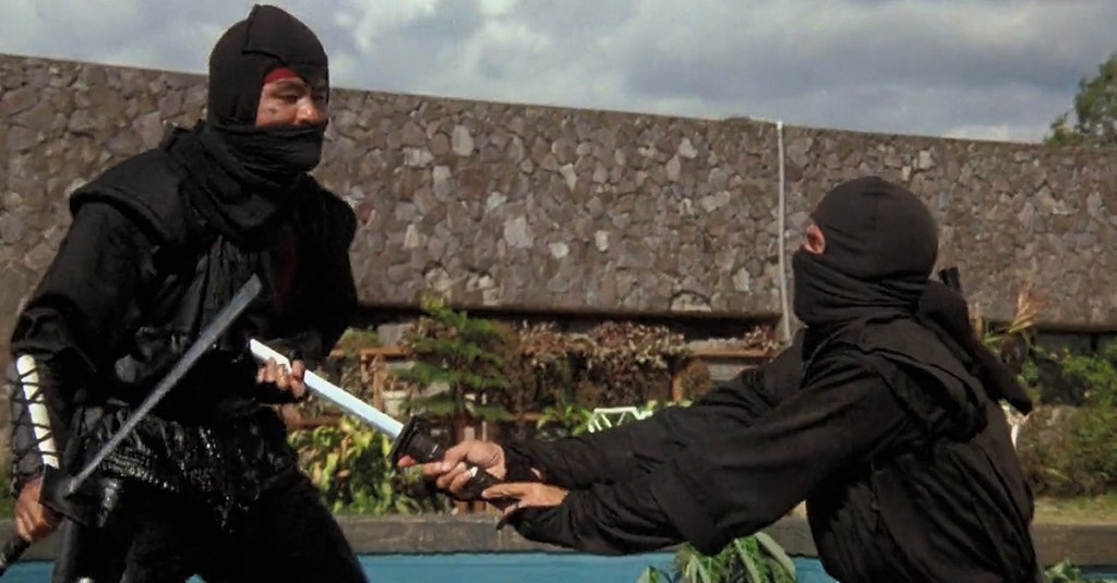 Joe (Michael Dudikoff) slays the Black Star Ninja (Tadashi Yamashita) in American Ninja (1985), Cannon Group