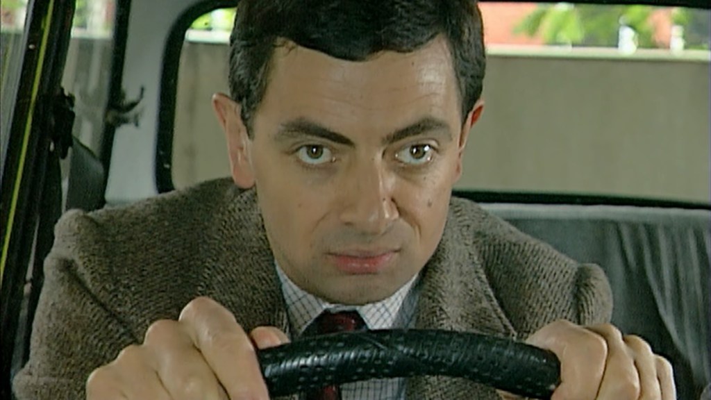 Mr. Bean (Rowan Atkinson) gets ready to exit the parking lot through the entrance in Mr. Bean Episode 3 "The Curse of Mr. Bean" (1991), Tiger Aspect Productions