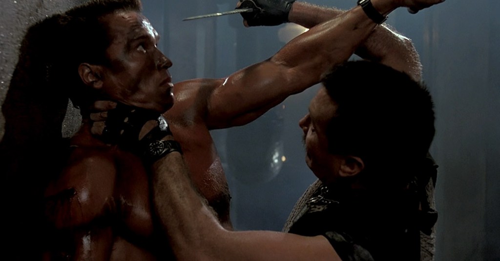 John Matrix (Arnold Schwarzenegger) fights Bennett (Vernon Wells) to the death in Commando (1985), 20th Century Fox