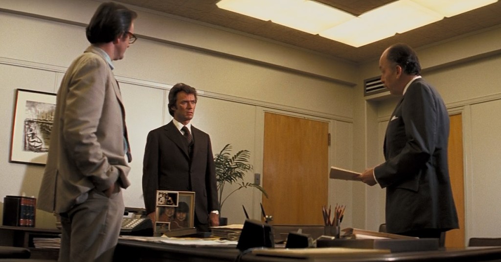 Harry Callahan (Clint Eastwood) is chastised for his policing techniques in Dirty Harry (1971), Warner Bros.