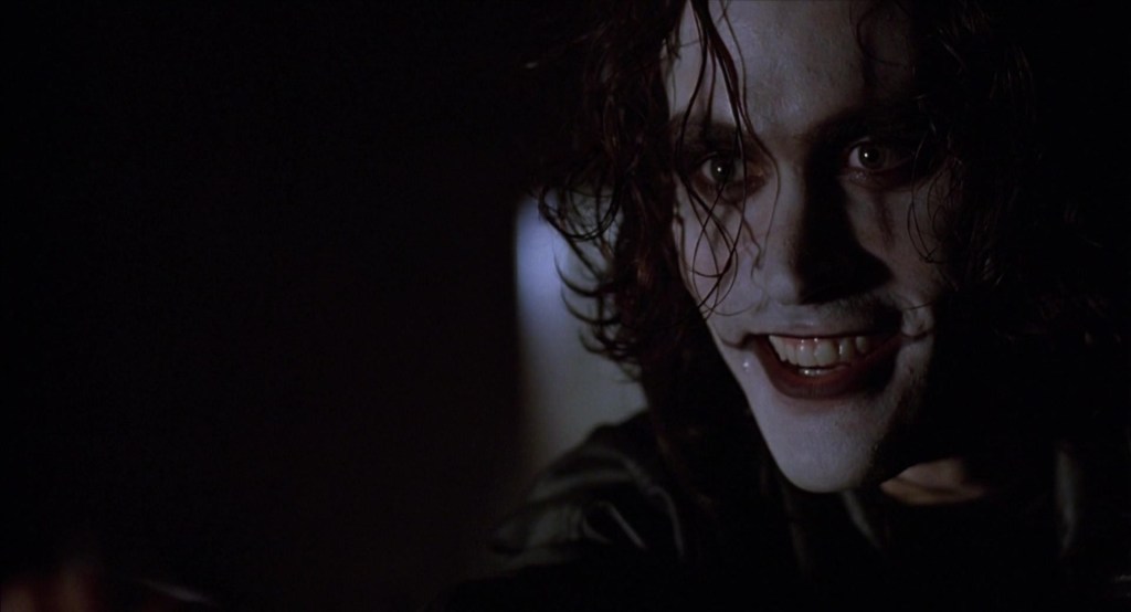 Eric Draven (Brandon Lee) tells Funboy (Michael Masse) to say his prayers in The Crow (1994), Miramax Films
