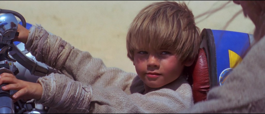 Anakin Skywalker (Jake Lloyd) shows off his custom ride in Star Wars: Episode I - The Phantom Menace (1999), Lucasfilm