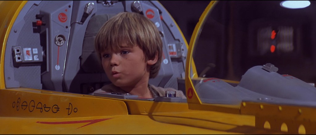 Anakin Skywalker (Jake Lloyd) finds a hiding place inside the cockpit of a Naboo Starfighter in Star Wars: Episode I - The Phantom Menace (1999), Lucasfilm