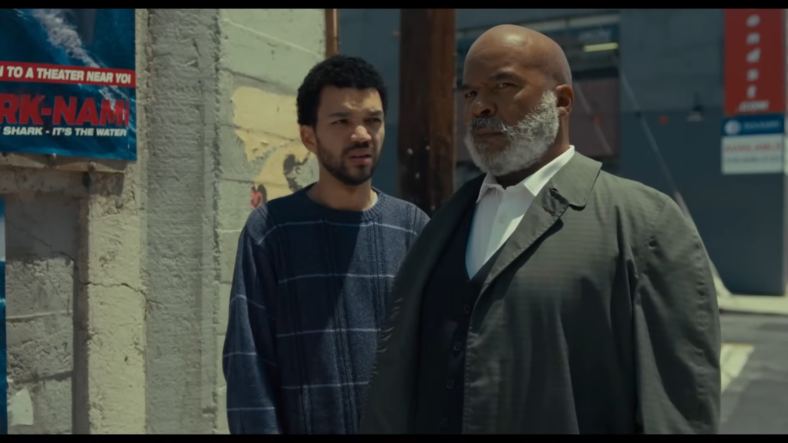 Justice Smith as Aren and David Alan Grier as Roger in The American Society of Magical Negroes (2024), Focus Features