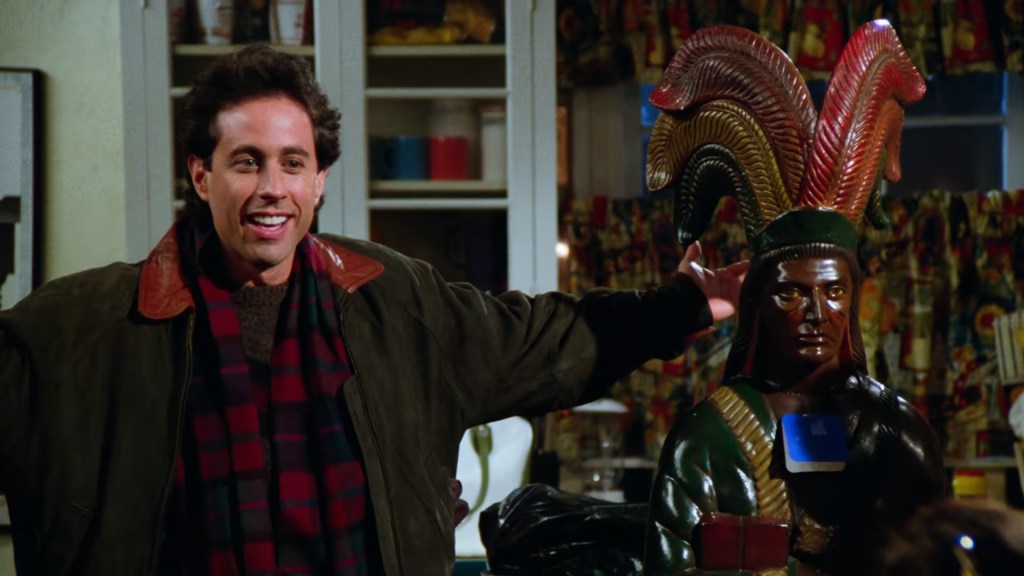 Jerry (Jerry Seinfeld) has a very special gift for Elaine (Julia Louis-Dreyfus) in Seinfeld Season 5 Episode 10 "The Cigar Store Indian" (1993), NBC