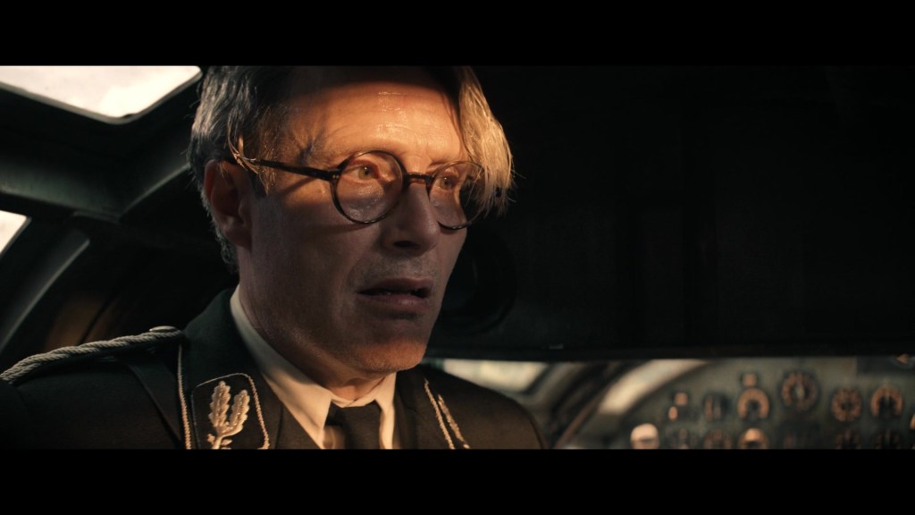 Voller (Mads Mikkelsen) realizes his time travel plans have gone awry in Indiana Jones and the Dial of Destiny (2023), Lucasfilm