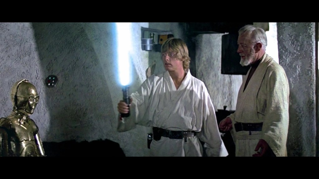 Luke Skywalker (Mark Hamill) ignites a lightsaber for the first time in Star Wars - Episode IV: A New Hope (1977), Lucasfilm