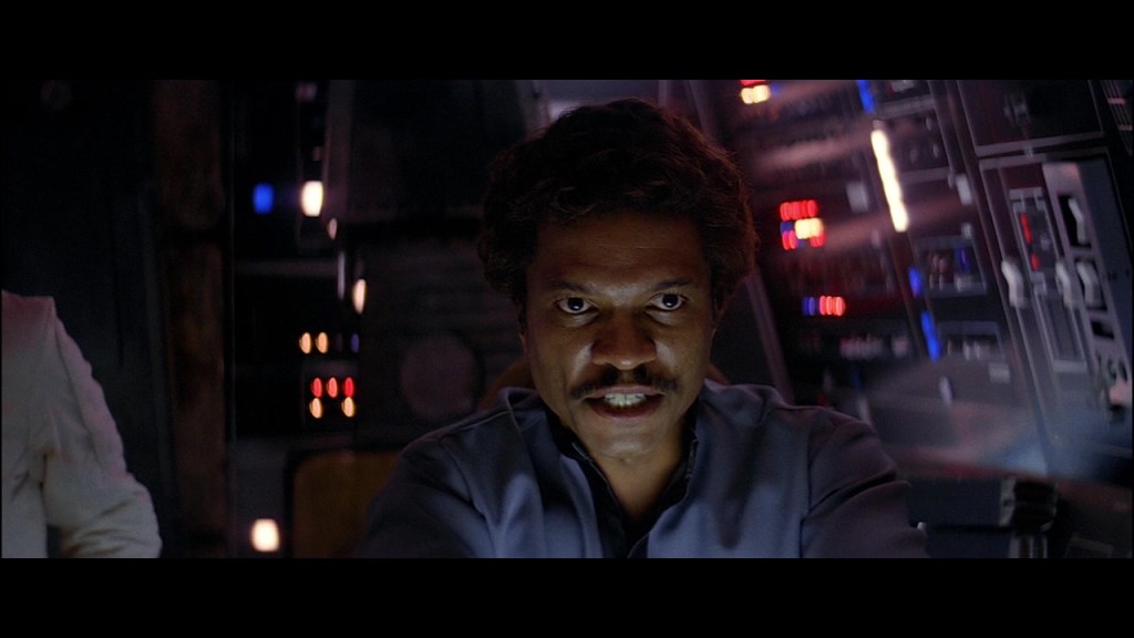 Lando Calrissian (Billy Dee Williams) takes the helm of the Millenium Falcon in Star Wars Episode V: The Empire Strikes Back (1980), Lucasfilm