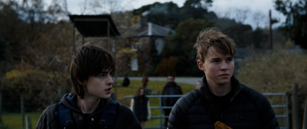 (From L to R) Jaeden Martell and Maxwell Jenkins as Joseph and Thomas in the action horror film Arcadian. Image property of RLJE Films.