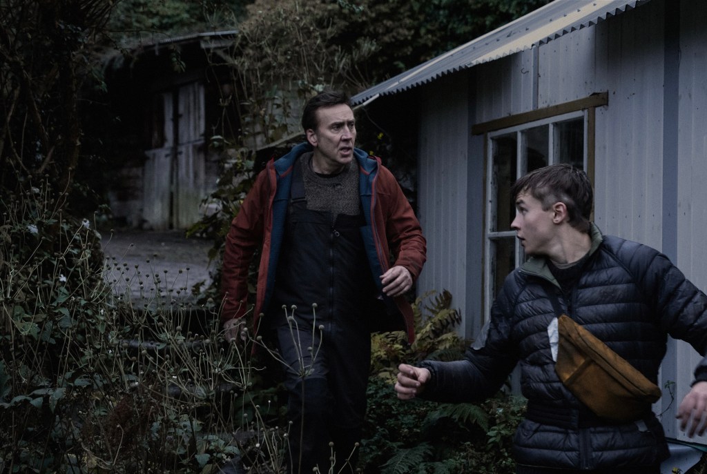 (From L to R) Nicolas Cage and Maxwell Jenkins as Paul and Thomas in the action horror film Arcadian. Image property of RLJE Films.