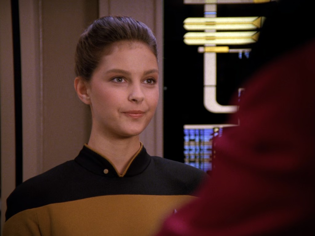 Geordi La Forge (LeVar Burton) informs Commander William Riker (Jonathan Frakes) about Ensign Robin Lefler's (Ashley Judd) promotion in Star Trek: The Next Generation Season 5 Episode 6 "The Game" (1993), Paramount