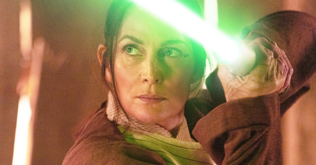 Jedi Master Indara (Carrie-Anne Moss) draws her lightsaber in The Acolyte (2024), Disney