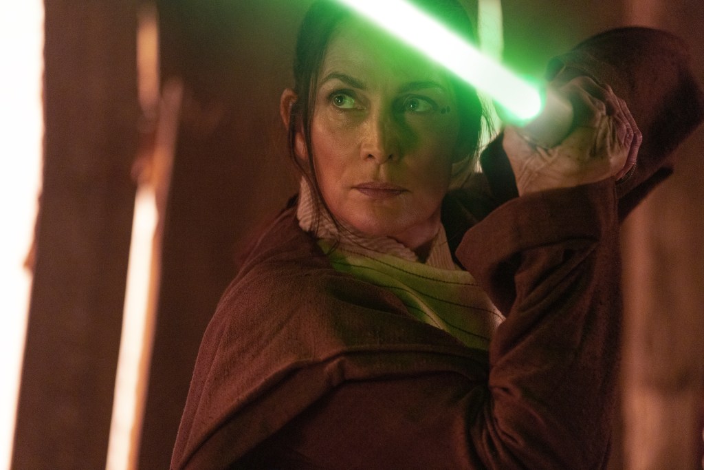 Jedi Master Indara (Carrie-Anne Moss) draws her lightsaber in The Acolyte (2024), Disney